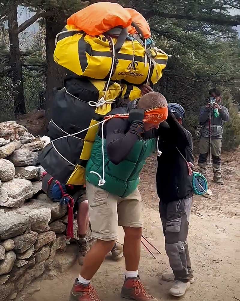 Porter carrying heavy pack